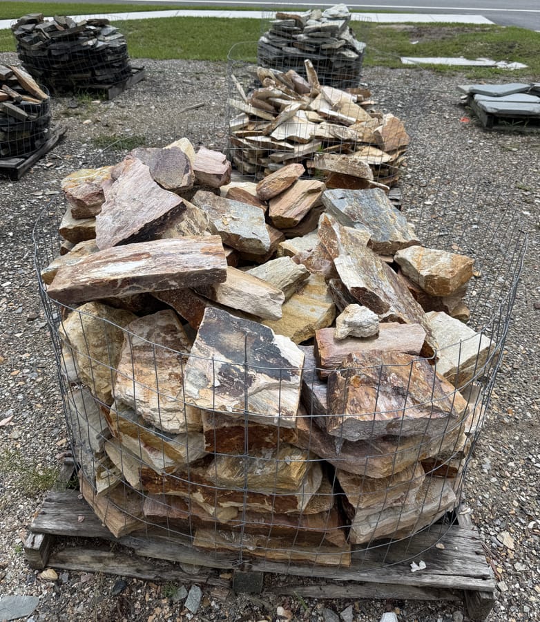 Bins of mixed tan and brown flagstone at the DeLand yard