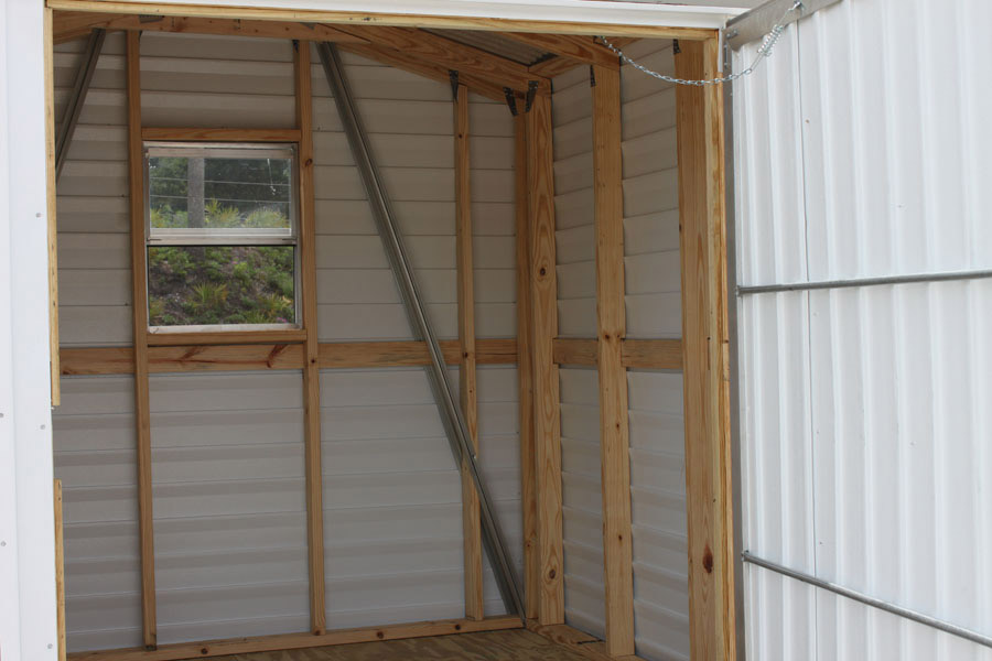 Interior of an aluminum storage shed showing window detail